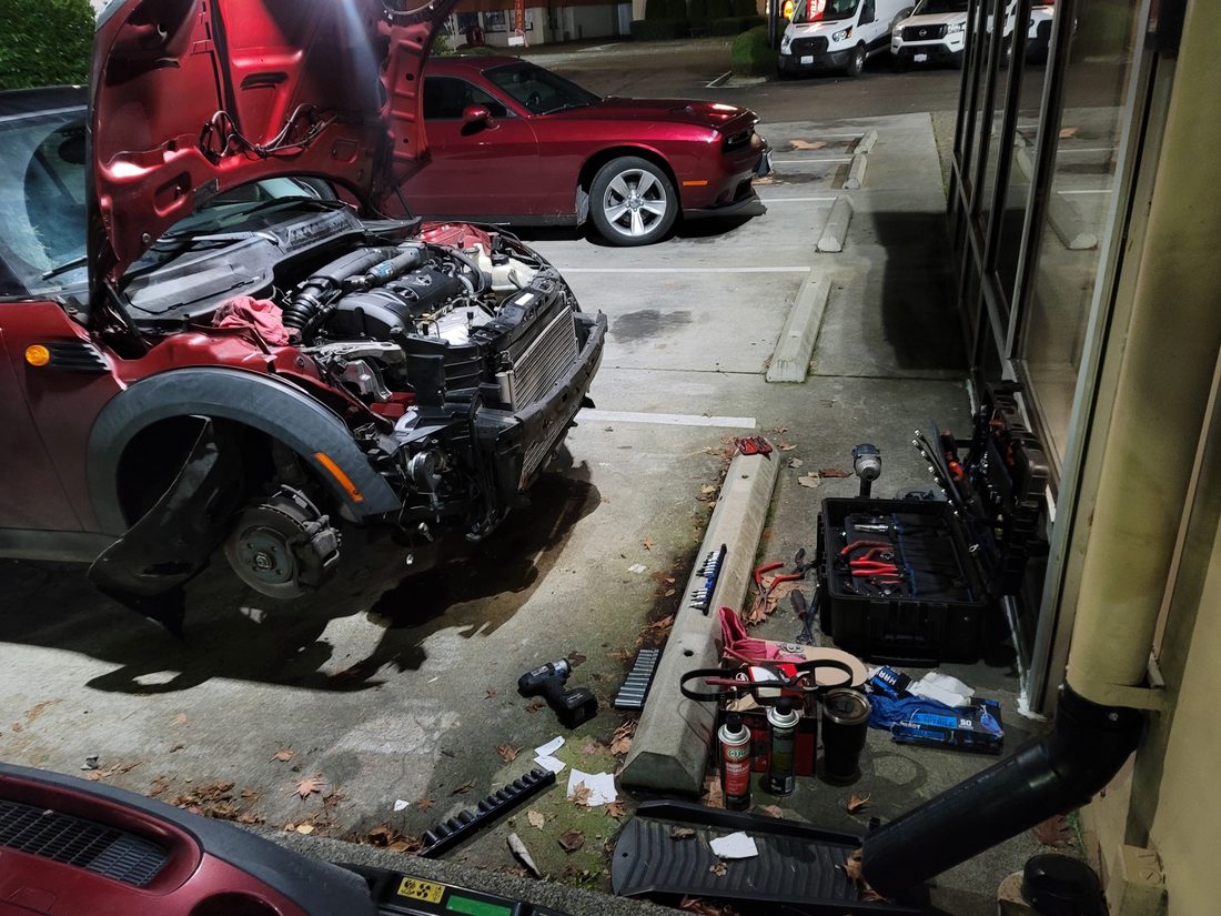 Mobile mechanic performing an on-site roadside repair at night
